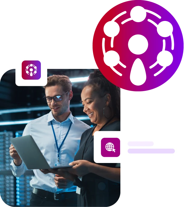 Two people in a server room looking at a laptop