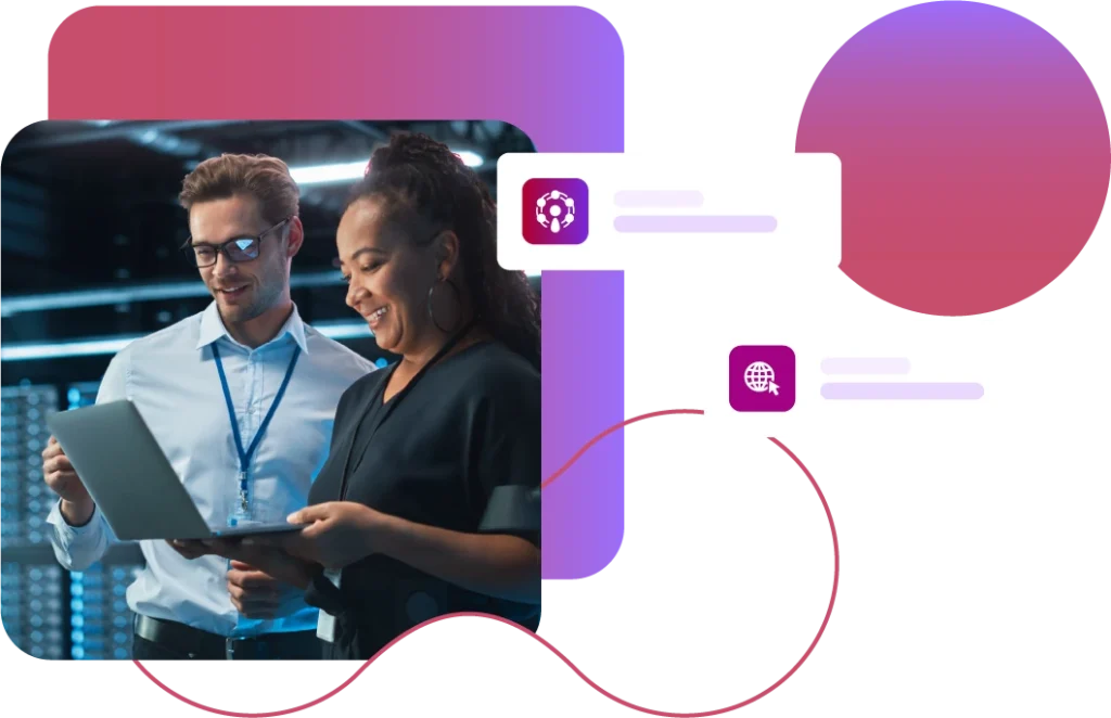 Two people in a server room looking at a laptop